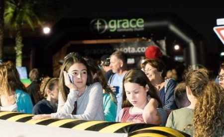Group of Girls at Grace Church Event in front of Custom Inflatable Arch