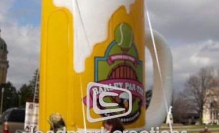 giant custom inflatable Par-Tee beer mug on parade float