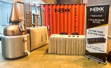 Inbox Beverage Distillery's custom inflatable fermentation display in booth space