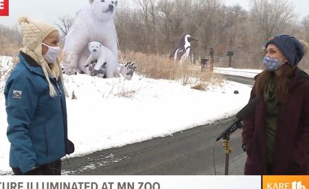 Lee Valsvik of Kare 11 and Stephanie Meacham in front of inflatable animals at the Minnesota Zoo