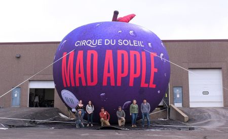 Team Landmark group shot in front of Mad Apple custom inflatable for Cirque du Soleil