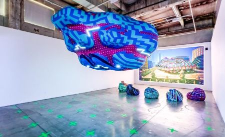 custom inflatable airship display hovers above set of bean bags